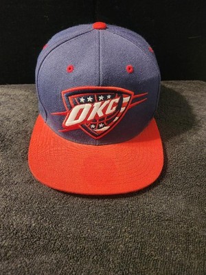 Oklahoma City Thunder Mitchell & Ness Navy Stars & Stripes Logo Snapback Hat.