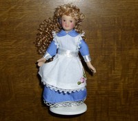 Girl With Blonden Curls Und Blue Dress With White Apron Girl With Blonden Curls Und Blue Dress With White Apron