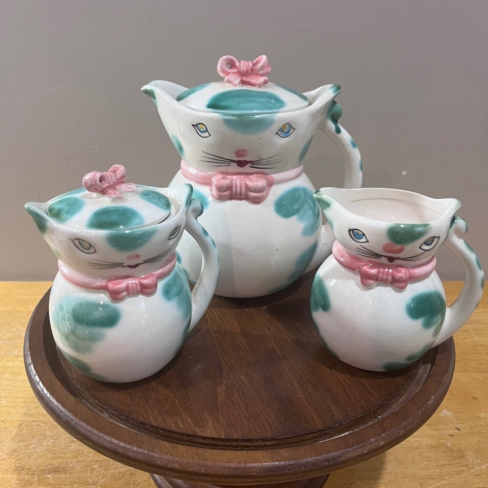 A genuine mid-century Made-in-Japan kitsch cat tea set with teal polka dots and pink bows — the kind of whimsical vintage tableware that stops guests in their tracks.