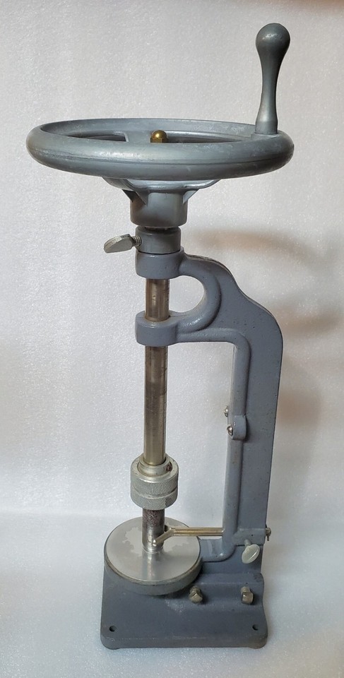 A cast-iron cork boring machine from a real science lab — brutally handsome industrial tool that doubles as a killer conversation-piece paperweight.