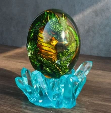 Green Fossil Dragon Hatchling Sleeping in Crystal Acrylic Glass Egg Figurine