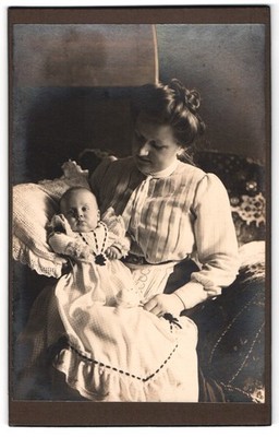 Photography Portrait Mother With Her Child On Lap Posing For Camera 