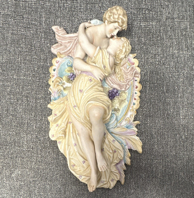 Capodimonte-style bisque porcelain wall plaque depicts a romantic scene of love