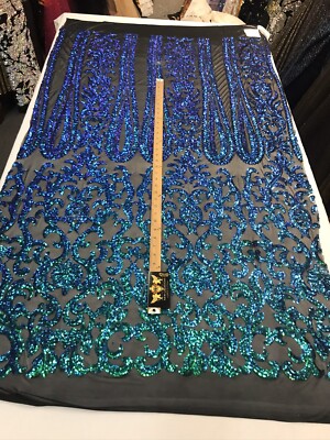GREEN IRIDESCENT CLASSIC SEQUIN DESIGN ON A 4 WAY STRETCH BLACK MESH-BY YARD.