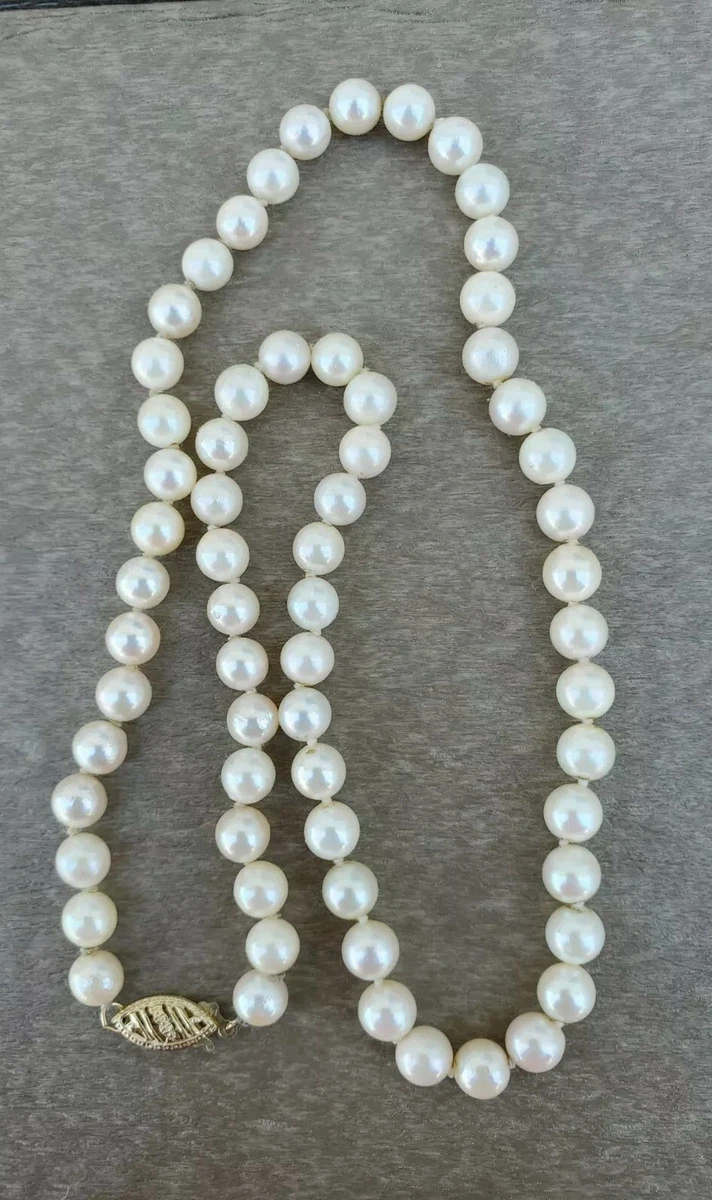 White pearl necklace with a 14ct gold T Bar clasp