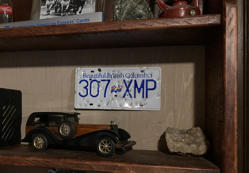 Unique License plate decor British Columbia plate with bullet and shell holes !!