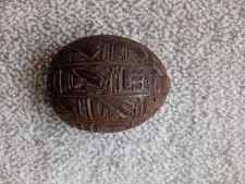 Egyptian scarab beetle, antique style artifact with detailed ancient hieroglyphs