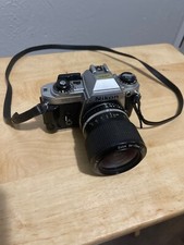 Silver Nikon FG 35 mm SLR/Nikon E 36-72 mm zoom lens