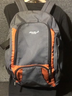 grey and orange backpack