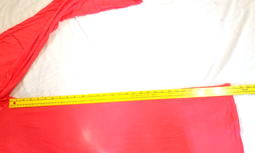 Bright pink stretch yoga pants, size 2X, with yellow measuring tape showing red fabric folded on a light gray surface.