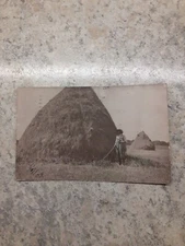 1909 RPPC Farmer by Huge Pile of Hay