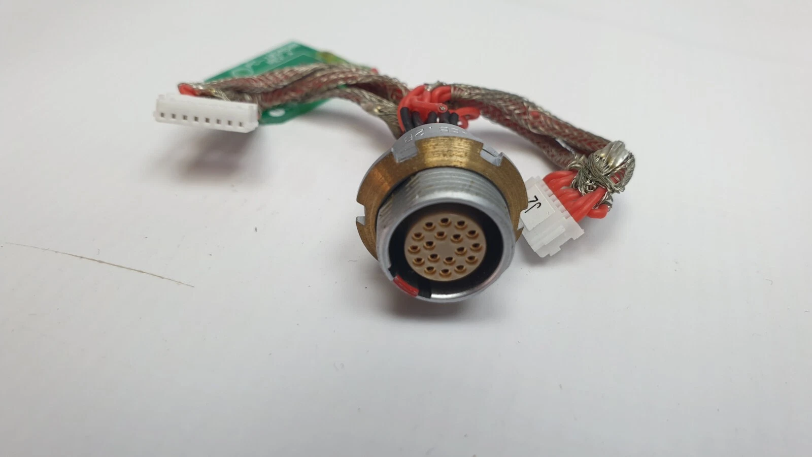 Face of the circular socket with gold contacts and J2 wire-to-board connector