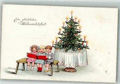 38167622 - Children Singing Before the Light Up Christmas Tree WSSB 1955 Christmas