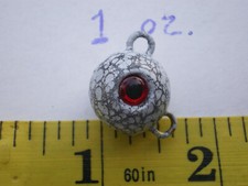25 PCS. FLUKE EAR BALL JIGS 1 OZ. WHITE/BLACK VEIN W/RED 3D EYE & #2 BRASS EYE