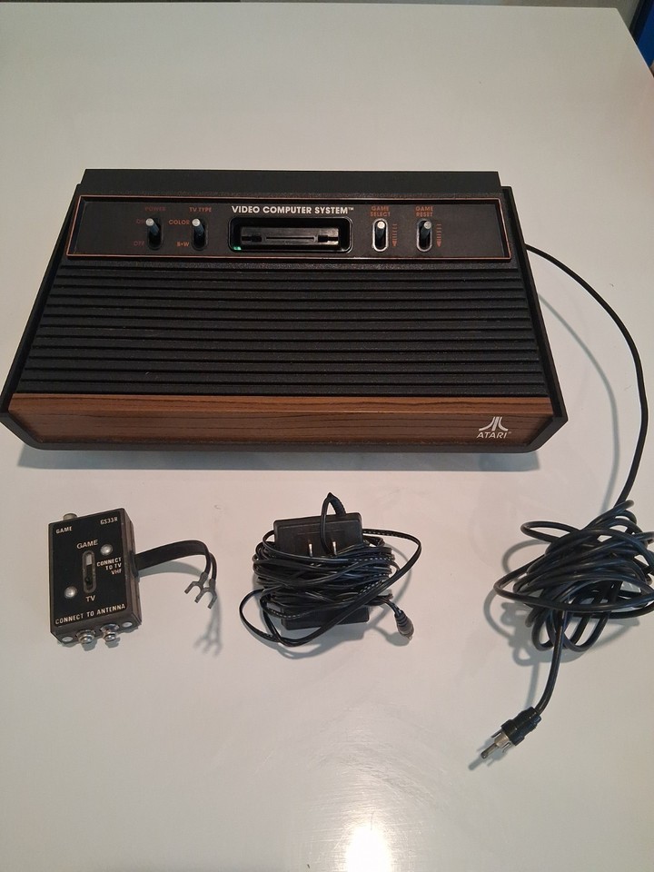 The iconic wood-grain Atari 2600 — THE console that started the home gaming revolution, complete and tested working.