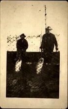 Men hauling up large fish ~ deep sea fishing? RPPC real photo ca. 1910