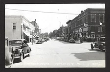 Forest City Iowa IA c1939 RPPC Main St S, Corner Drug, Cafe, Bakery, Hotel, Cafe