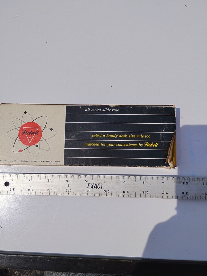 A Pickett all-metal slide rule in its original box — the gold standard of analog calculators, still in factory-fresh presentation and ready to impress.