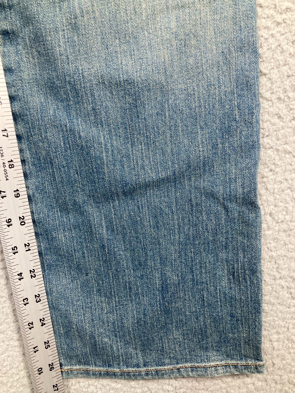 Blue stretch light wash Karen Kane women’s jeans, 6, with measuring tape across the waistband.