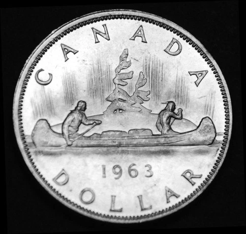 1963 $1 silver coin that is AU and in a paper flip. Gorgeous