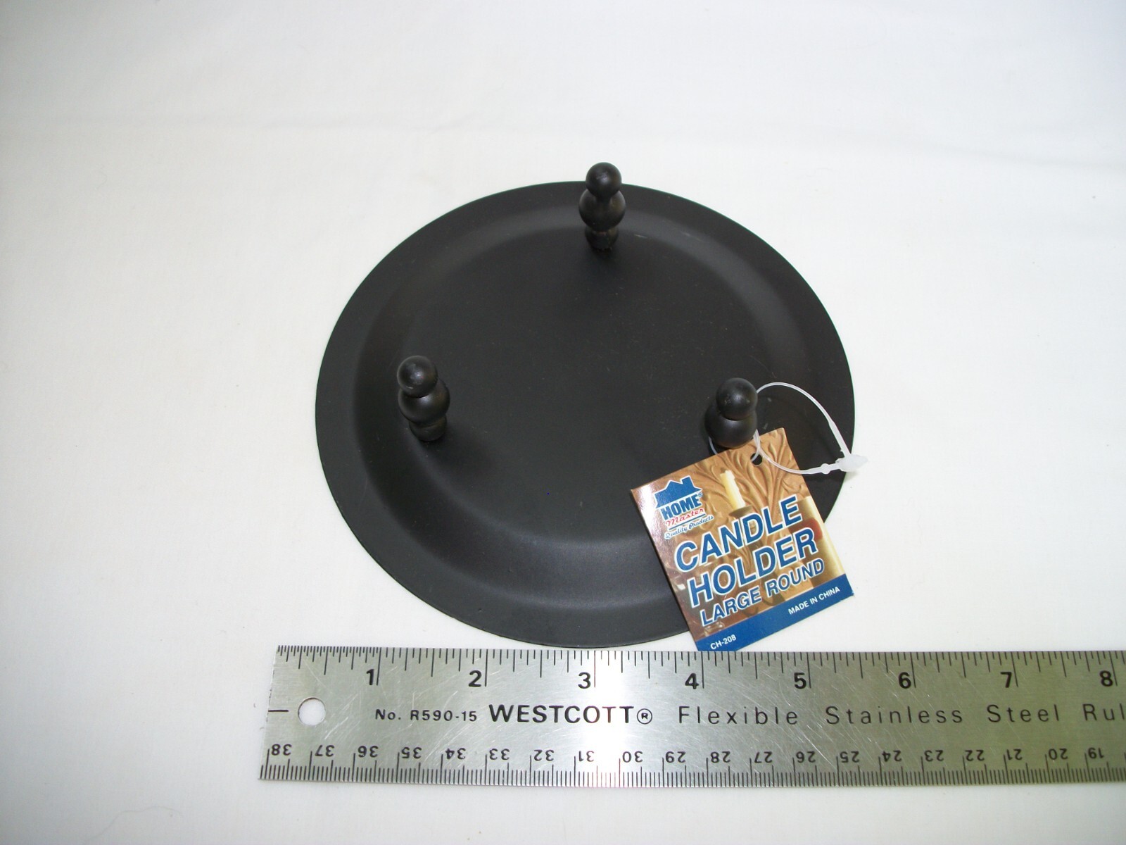 Iron artwork footed candle holder 5-3/4 inches in diameter and 1-5/8 tall