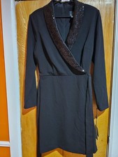 Classic Adrianna Papell dress in solid black. Sleek, simple silhouette with a re