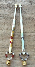 2 bone lace bobbins, painted to celebrate the millennium by Margaret Wall