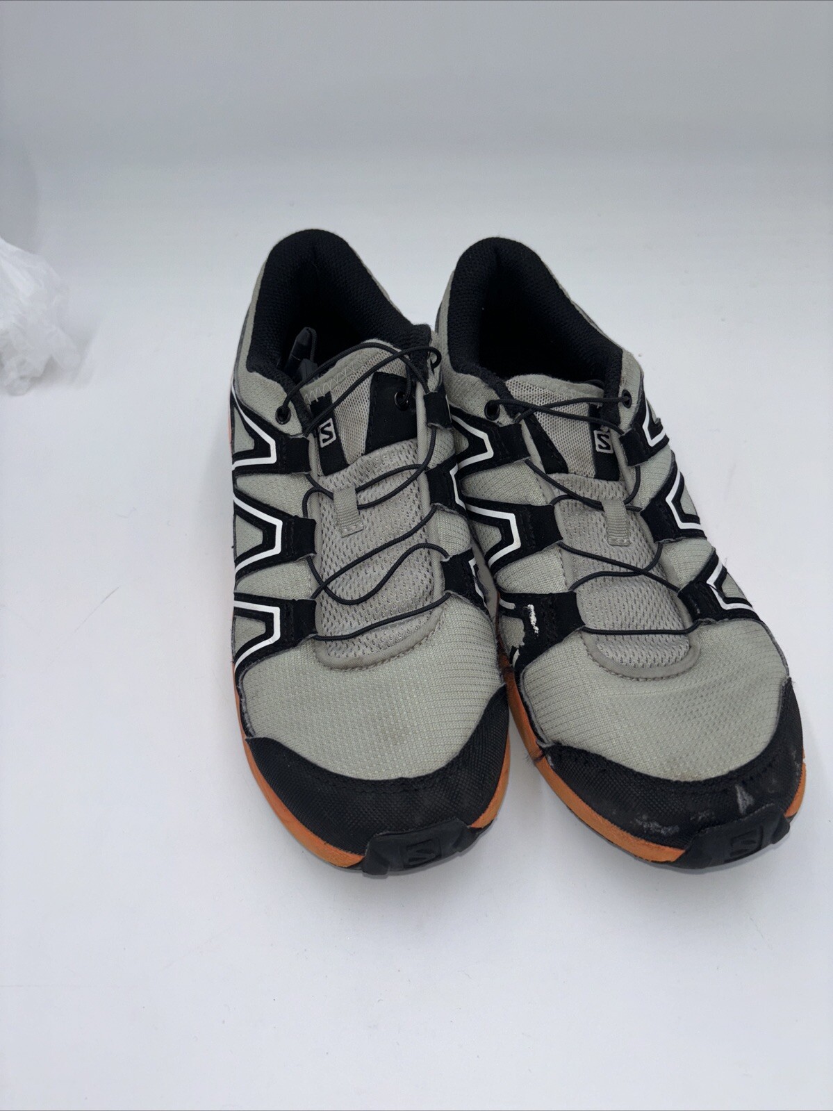 Scarpe da trail running Salomon Speedcross Junior taglia 6 nere e arancioni.