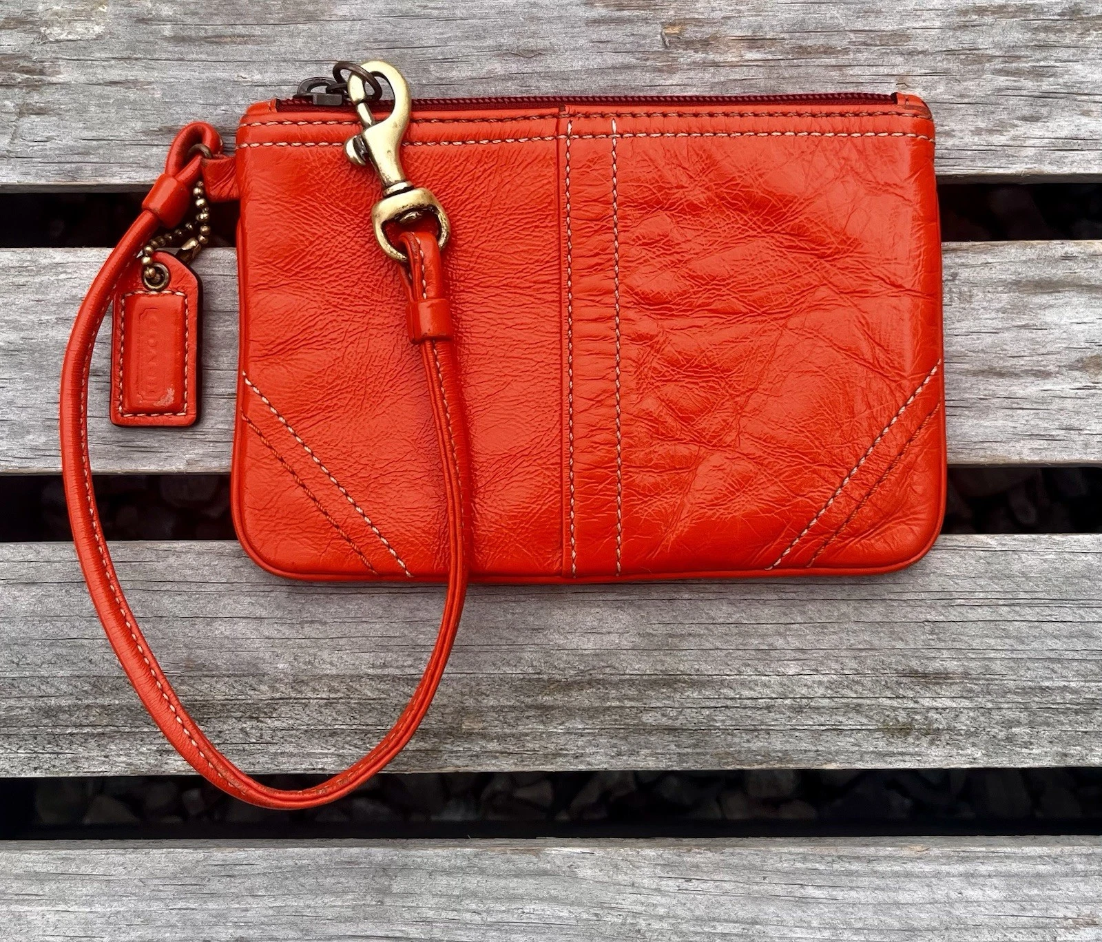 Polsino Coach vintage arancione in morbida pelle liscia con zip