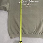 Gray vintage Eddie Bauer sweatshirt size L with yellow vertical measuring tape and black “Eddie Bauer Outfitting Since 1920” text.
