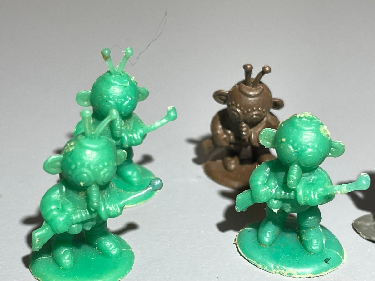 Vintage 60s plastic alien and astronaut figures in various poses 