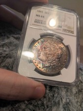 NGC MS 64 1885 Morgan, toned obverse and reverse