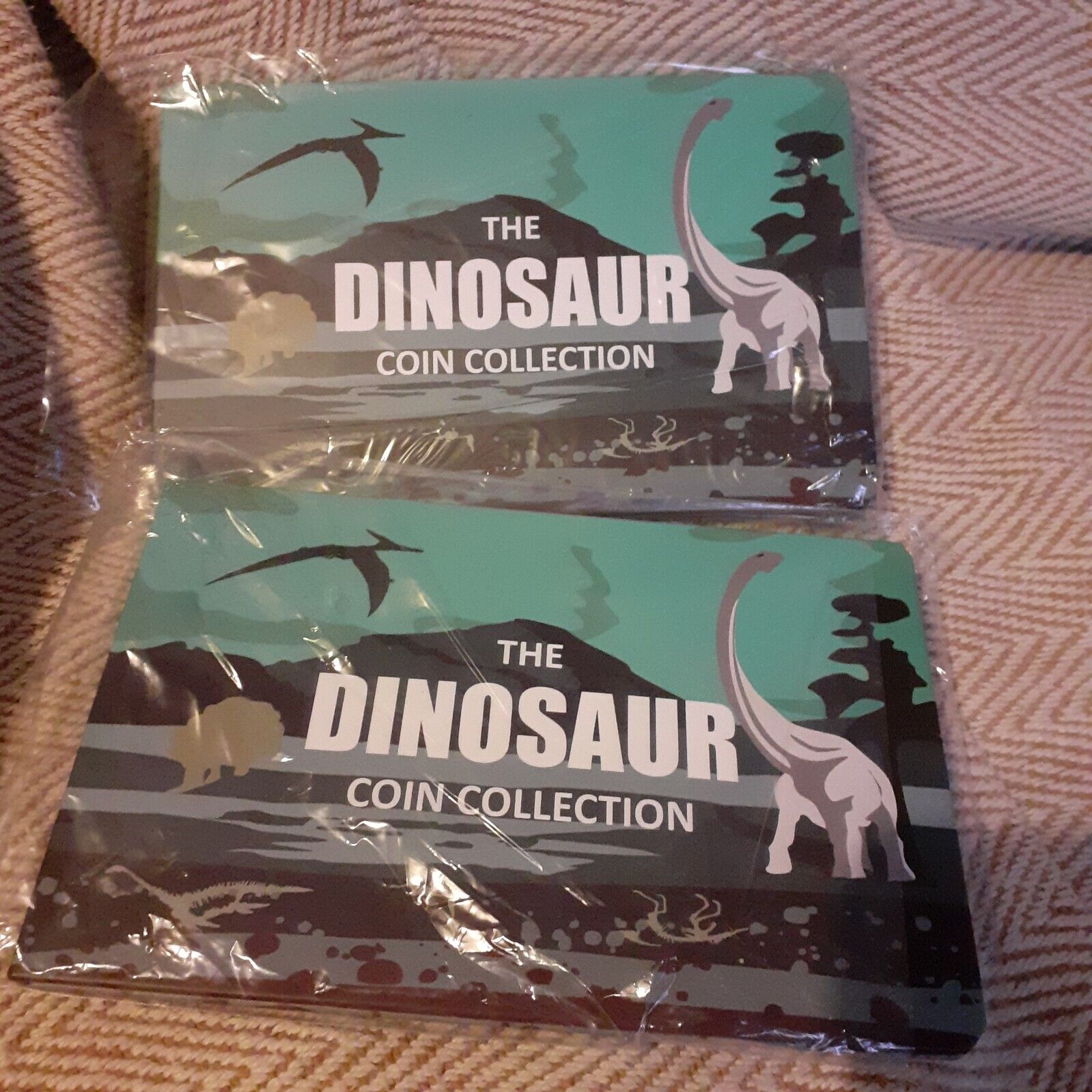 two Dinosaur  50p Collection Albums each holds all 6 royal mint dinosaur coins