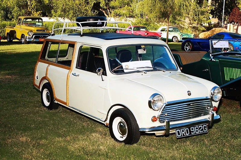 The Mini shows well. Note its rare full-length sunroof, which sits neatly under another period accessory—the roof rack.