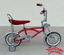 BICICLETA DOBLADA LOWRIDER COLLECTION 12" CROMADA/ROJA CON LLANTAS DE 72 RADIOS Y NEUMÁTICOS LOWRIDER