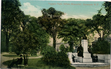 FAYETTE PARK, WHITE MEMORIAL, SYRACUSE, N.Y. BUILDINGS IN BACK. PEOPLE BY STATUE