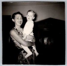 Vtg Snapshot Smiling Woman Holding Baby Indoors 1964