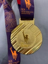 2025 New York City Marathon finishers' medal and Dunkin'Donuts NYCM '25 hat