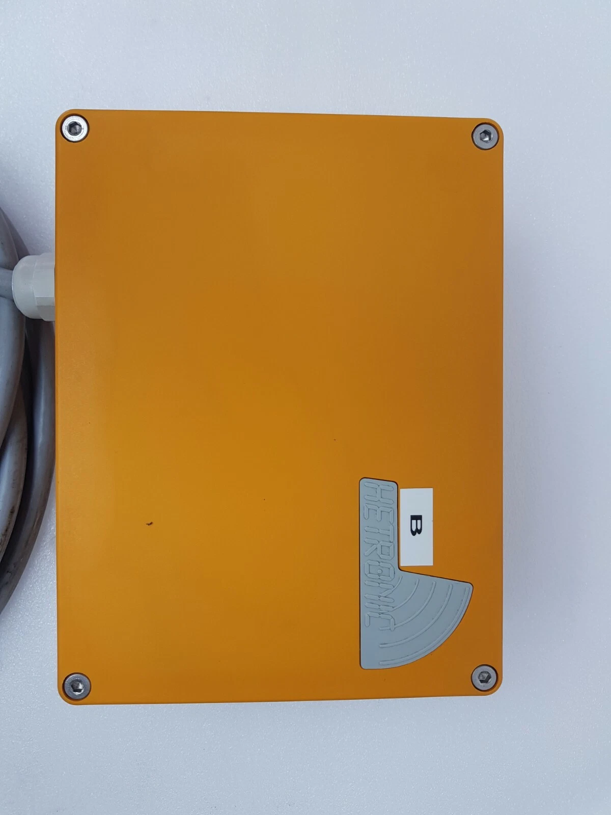 Top lid of the orange Hetronic receiver housing with Hetronic logo