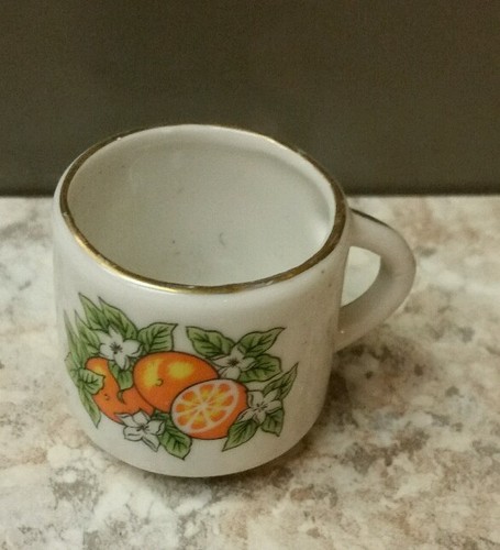 miniature white porcelain mug decorated with oranges, flowers and gold trim - Picture 2 of 3