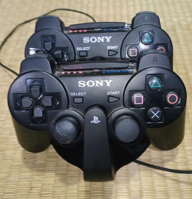 Lot (2) Sony PS3 DualShock 3 Wireless OEM Controllers + OEM Sony Charging Stand