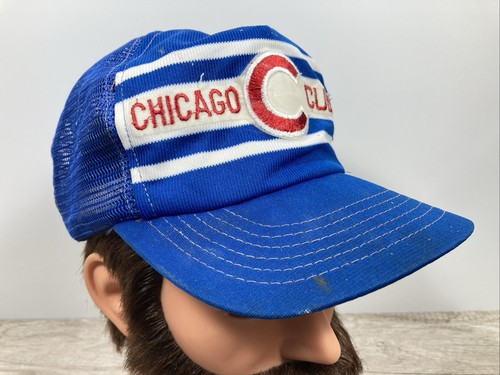Blue snapback trucker hat with white and white stripes, red “Chicago Cubs” text, and embroidered C logo on the front panel.
