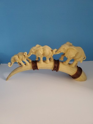 Three Elephants Parading On A Faux Tusk