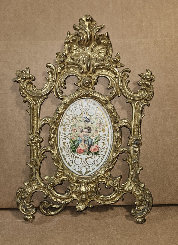 Antique  table vanity mirror features a cast metal brass frame