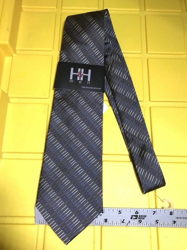 Navy blue neck tie with subtle horizontal stripes, black tag reading “H&H men 100% silk stain resistant Made in USA.”