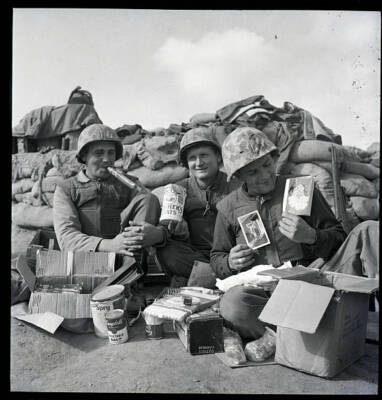 Korea Three happy Marines 1st Division here display their Xmas pres- 1952 Photo