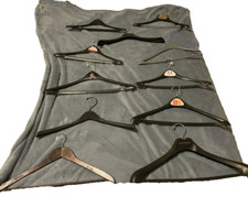 large lot of 11 curved plastic suit hangers some with pants rod  one wooden