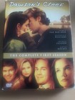 DVD cover of "Dawsons Creek" with couple in love, red title, and cast names at bottom.