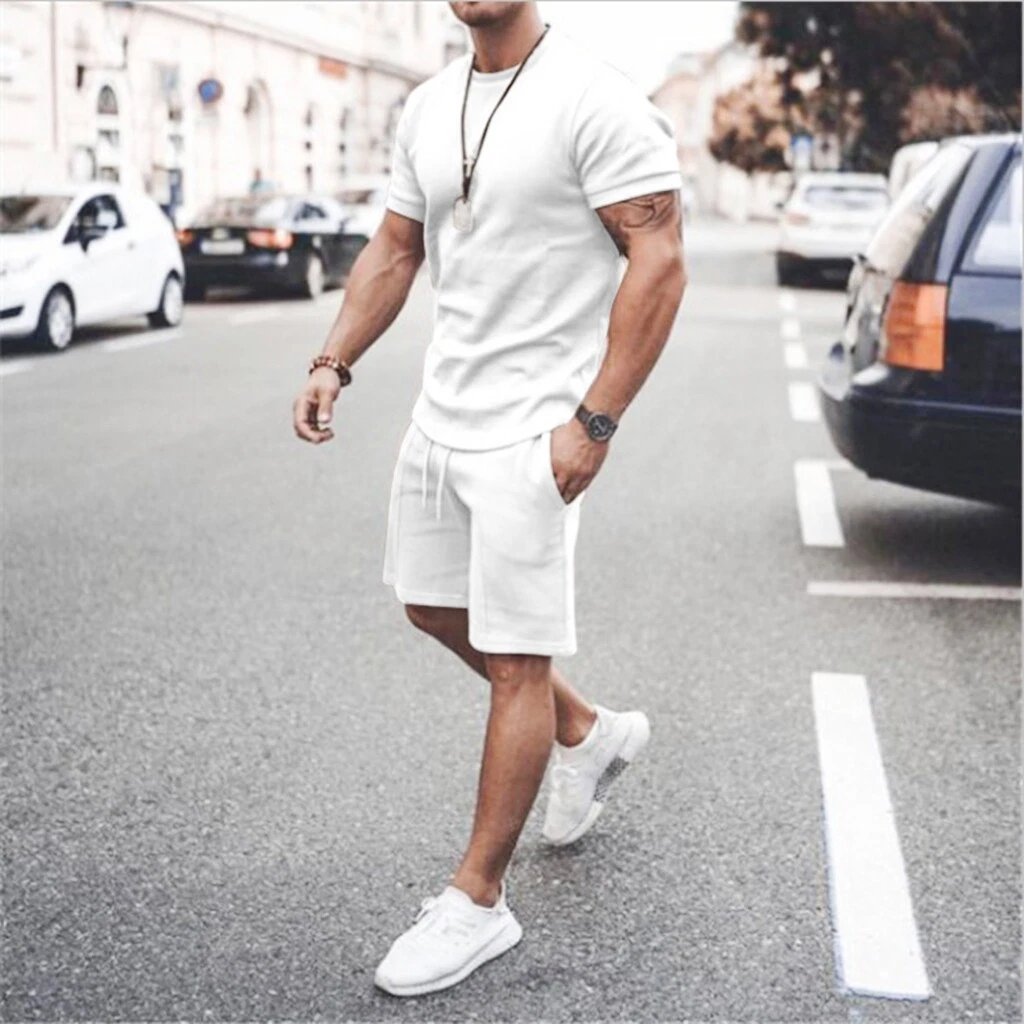 Looking for Success. Dressing in a white shirt, green pants, leather shoes,  a young black guy with mohawk hair is standing in the front of high buildi  Stock Photo - Alamy