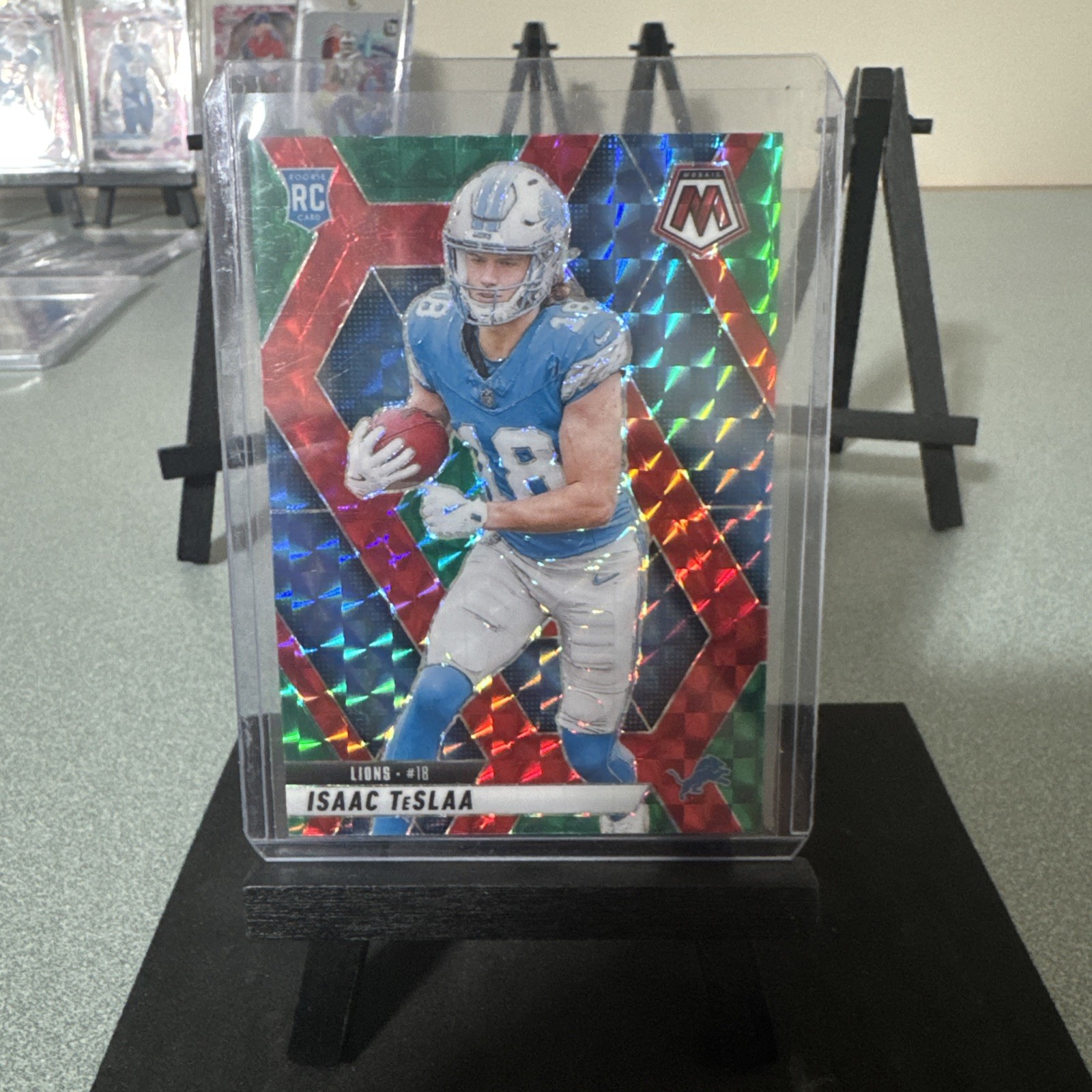 2025 Panini Mosaic Isaac Teslaa #319 RC Rookie Choice Prizm Red Green Lions